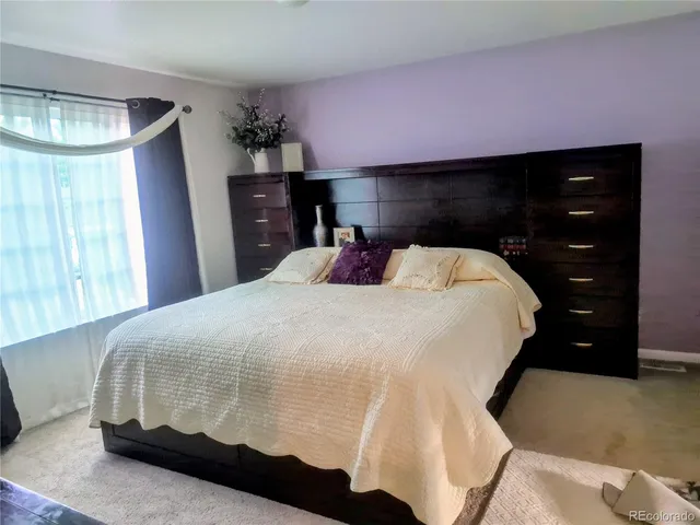a bedroom with a bed and a dresser