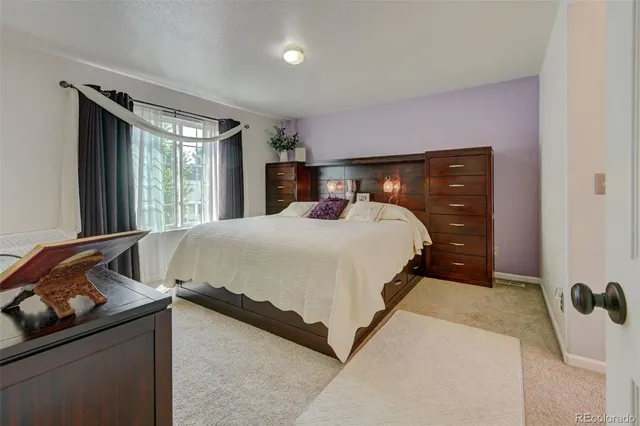 a bedroom with a bed and a dresser