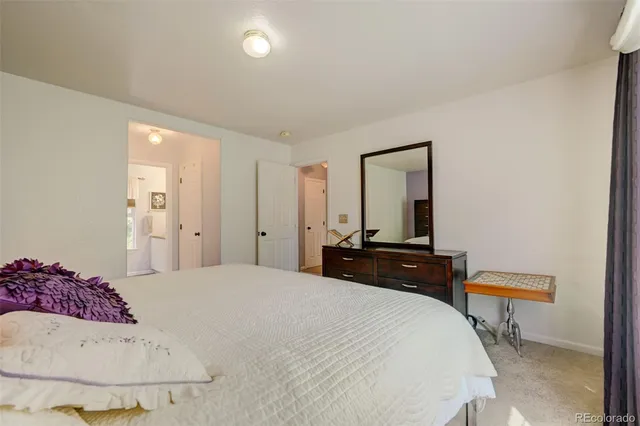 a bedroom with a bed and a mirror