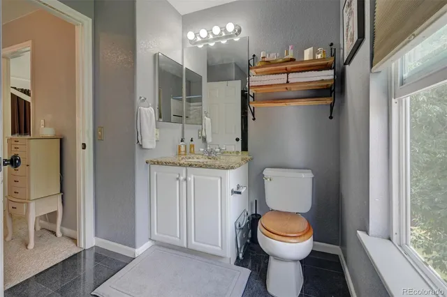 a white toilet sitting next to a bathroom sink