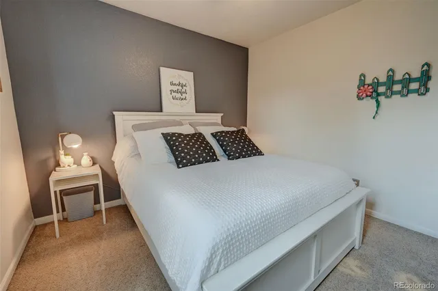 a bedroom with a bed and a table in it