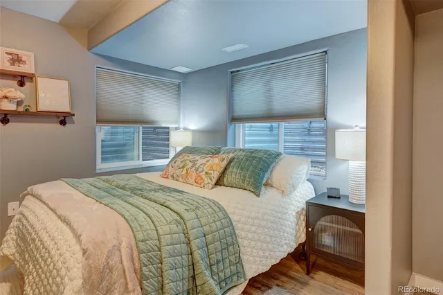 a bedroom with a bed and a painting on the wall