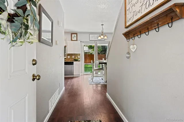 a view of hallway with wooden floor