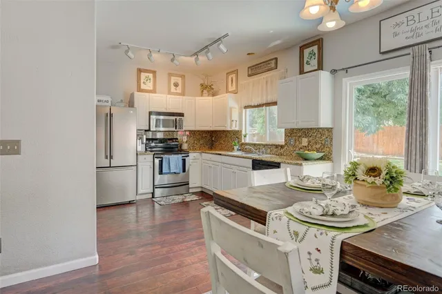 a kitchen with stainless steel appliances a stove a sink and a refrigerator