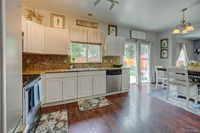 a kitchen with a sink stove and cabinets