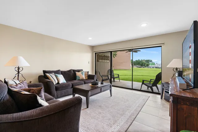 a living room with couch and a floor to ceiling window