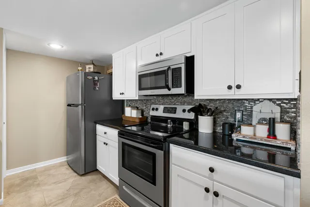 a kitchen with stainless steel appliances a stove a microwave and a refrigerator