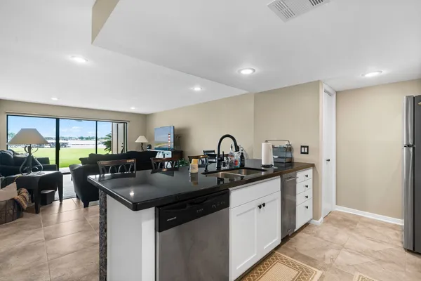 a kitchen with counter space a sink and cabinets