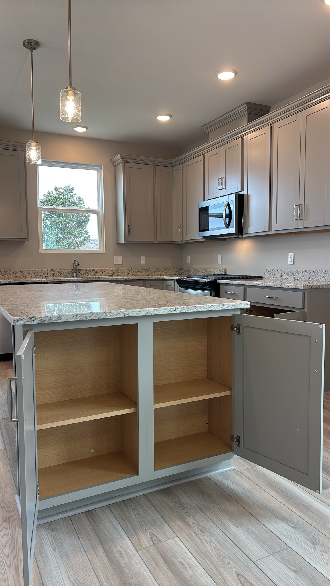 500 Compass Lebanon, TN 37090 - Photo 6 of 42 a kitchen with granite countertop white cabinets and white appliances