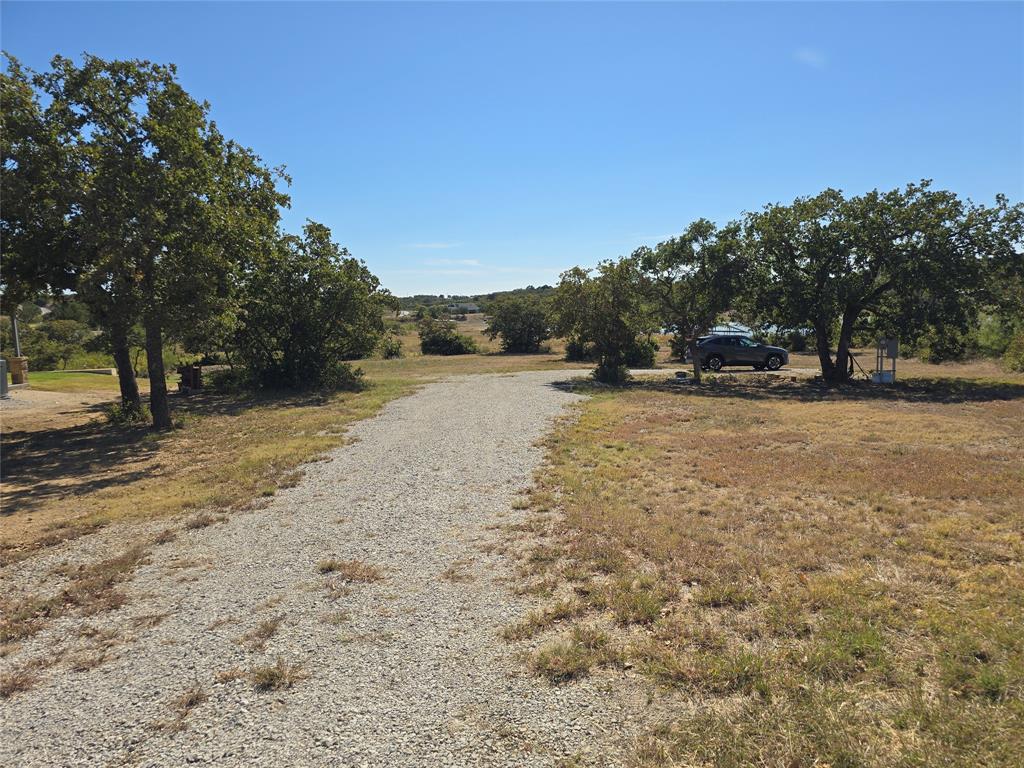 133 Scenic Ridge Drive, Unit LOT 22 Cisco, TX 76437 - Photo 16 of 22 a view of a yard with a tree