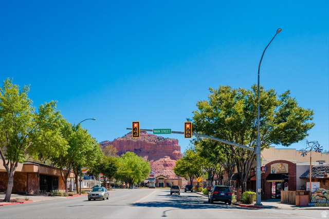 5615 East Eight Mile Gap Road Kanab, UT 84741 - Photo 79 of 81 View of asphalt road with traffic lights, street lighting, sidewalks, and curbs