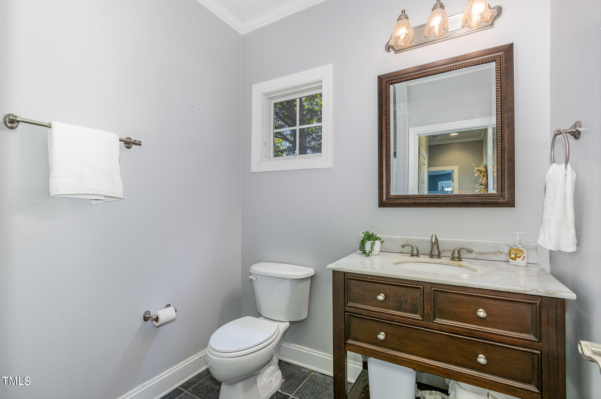 679 Roberts Chapel Road Stem, NC 27581 - Photo 15 of 28 a bathroom with a toilet sink vanity and mirror