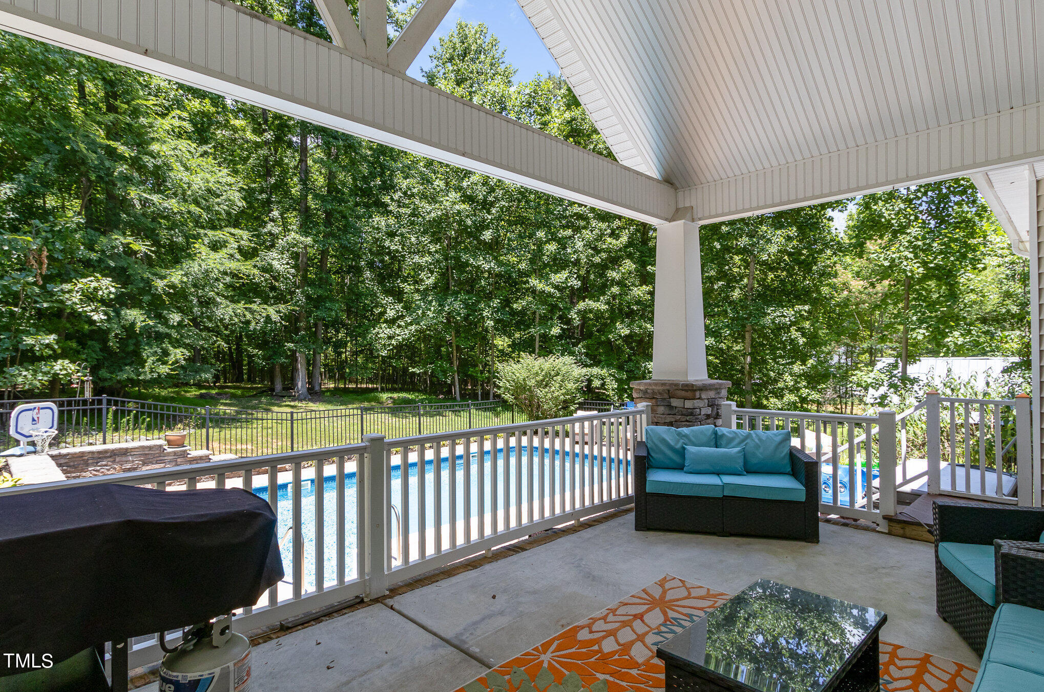 679 Roberts Chapel Road Stem, NC 27581 - Photo 21 of 28 a view of a patio with couches potted plants and a large tree
