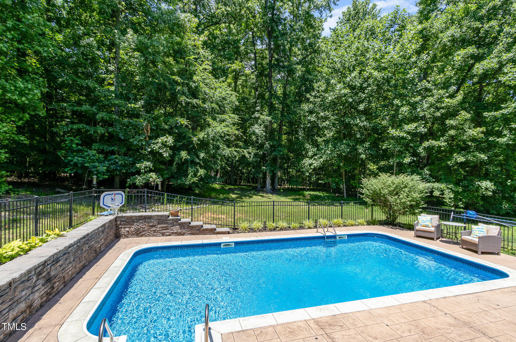 679 Roberts Chapel Road Stem, NC 27581 - Photo 22 of 28 a view of a swimming pool with a patio