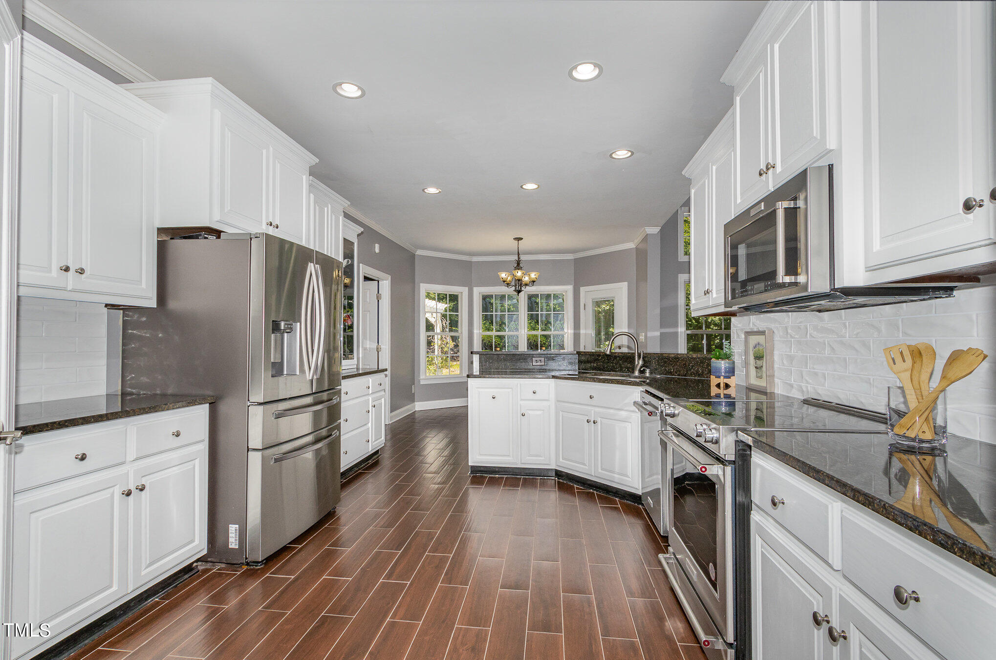 679 Roberts Chapel Road Stem, NC 27581 - Photo 7 of 28 a kitchen with white cabinets and stainless steel appliances