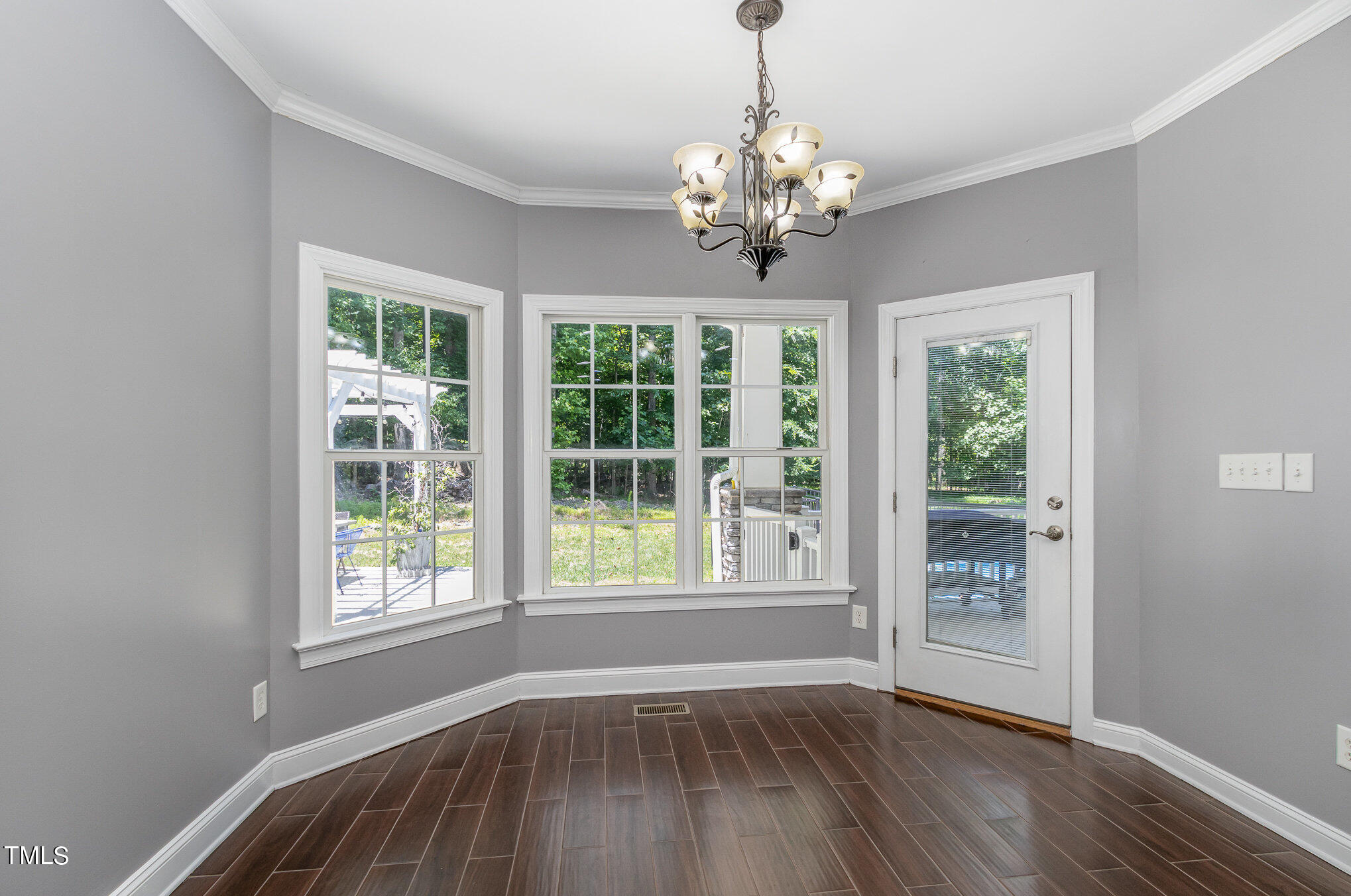 679 Roberts Chapel Road Stem, NC 27581 - Photo 8 of 28 a view of an empty room with wooden floor and a window