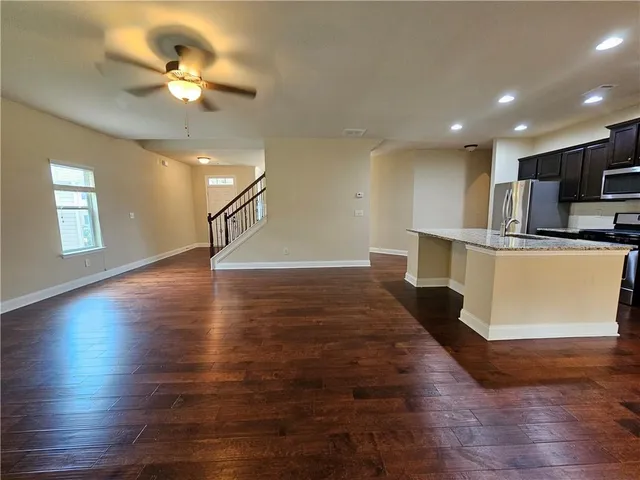 a bathroom with a granite countertop sink a mirror and vanity