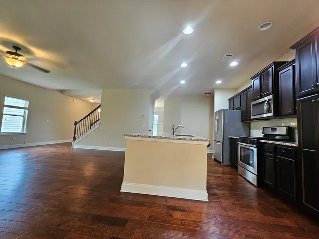 a metallic refrigerator freezer sitting in a kitchen