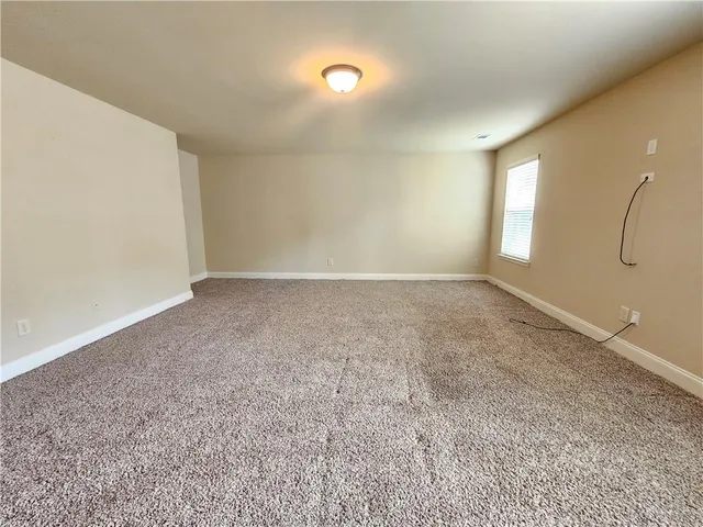 a view of a livingroom with a ceiling fan and window