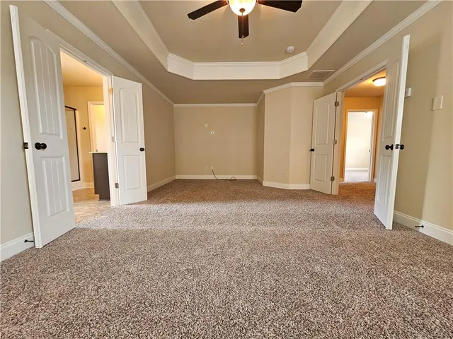 an empty room with windows and closet