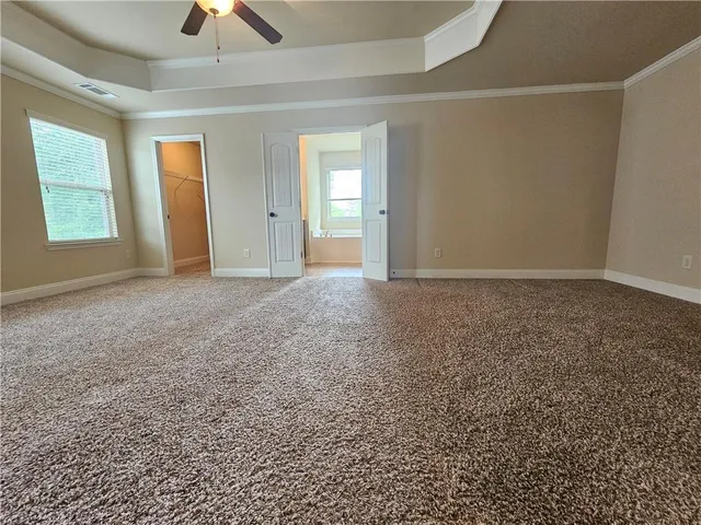 a white bath tub sitting next to a shower