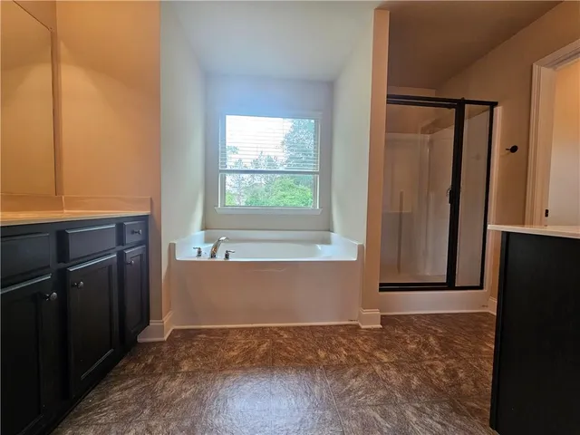 a bathroom with a bathtub and a shower