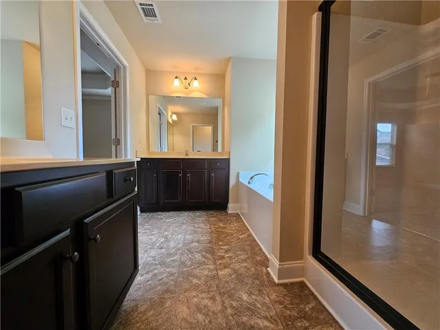 a view of a bathroom with a sink and a mirror