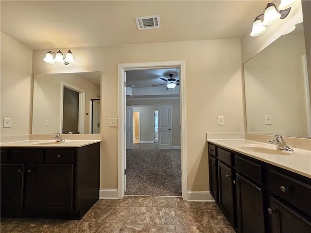 a white toilet sitting in a bathroom next to a window