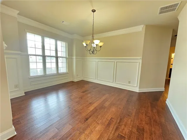 a view of a room with wooden floor and fan