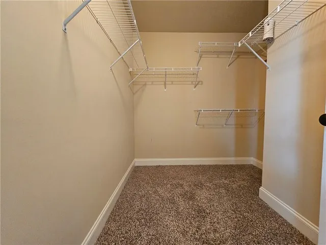 a bathroom with a double vanity sink a large mirror and shower
