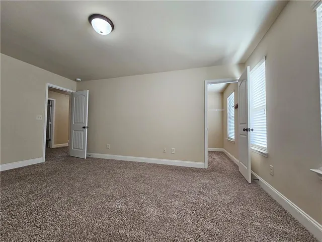 a bathroom with a toilet a sink a bath tub and mirror