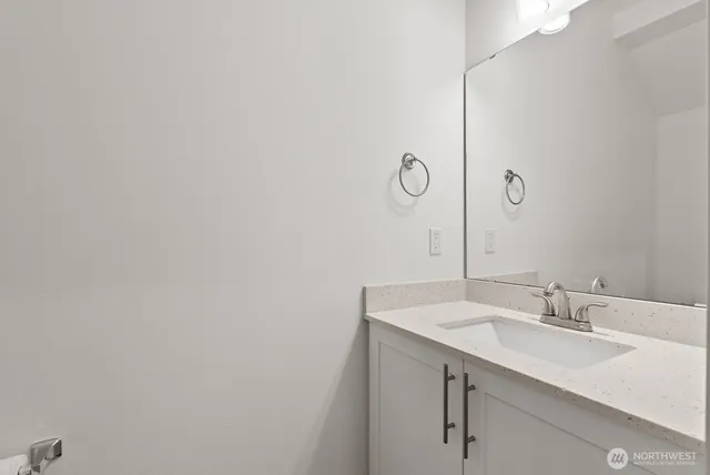 a bathroom with a sink and vanity