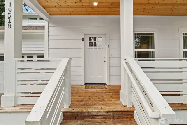 a view of a bedroom with wooden floor and stairs