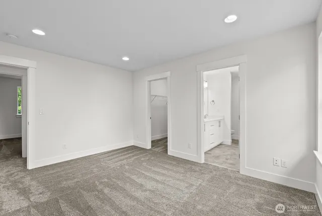 a bathroom with a tub a sink and mirror