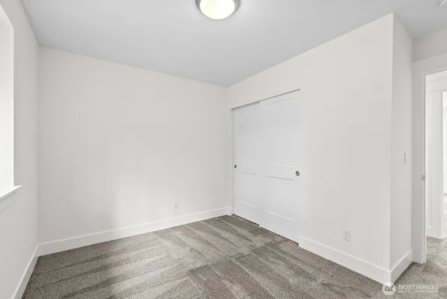 a bathroom with a sink a toilet a mirror and shower