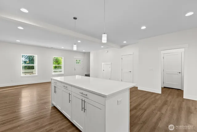 a view of center island wooden floor and windows