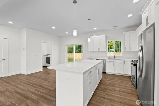 a kitchen with a sink stove and refrigerator