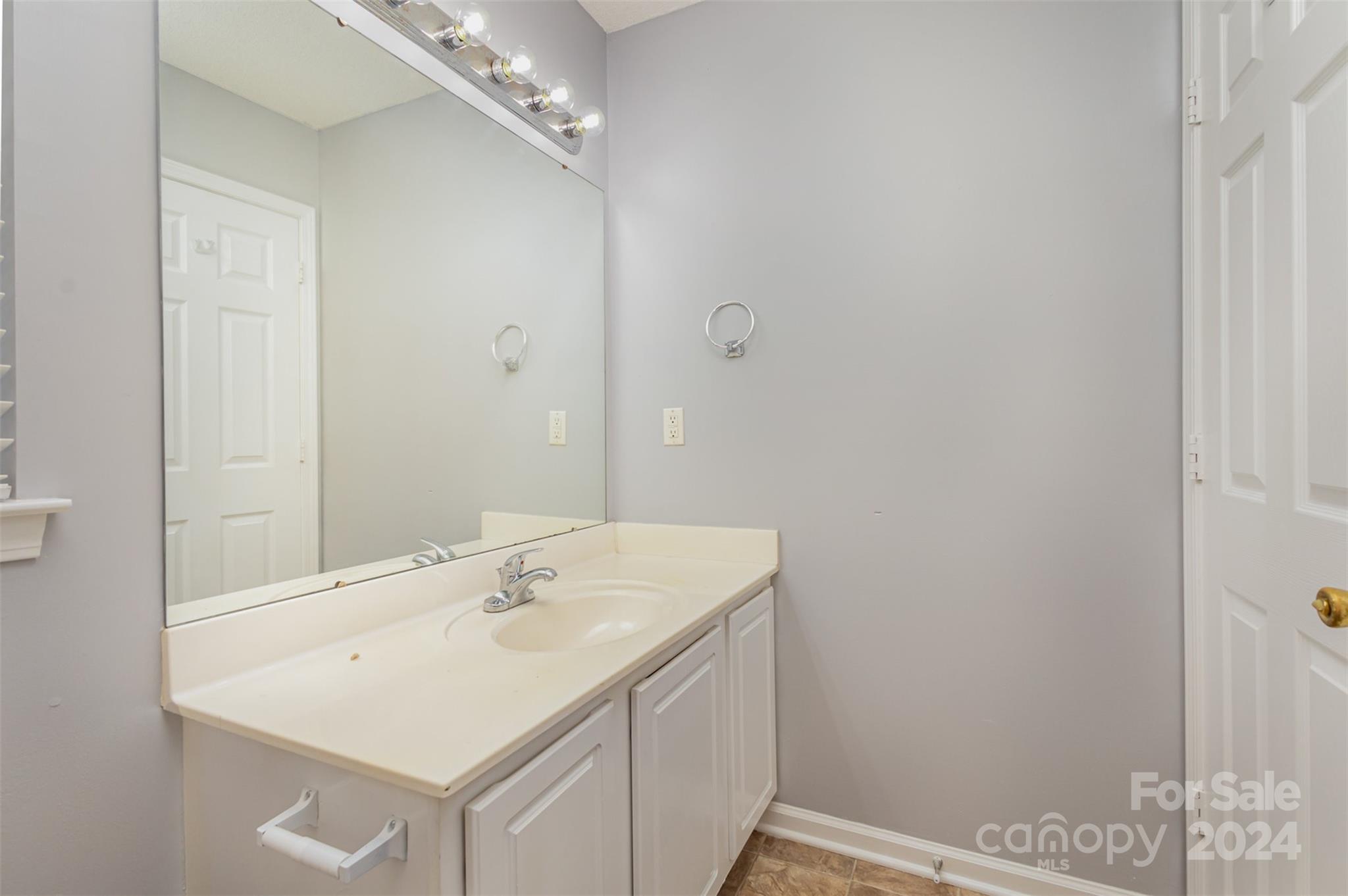 3917 Faith Church Road Indian Trail, NC 28079 - Photo 13 of 19 a bathroom with a sink and a mirror