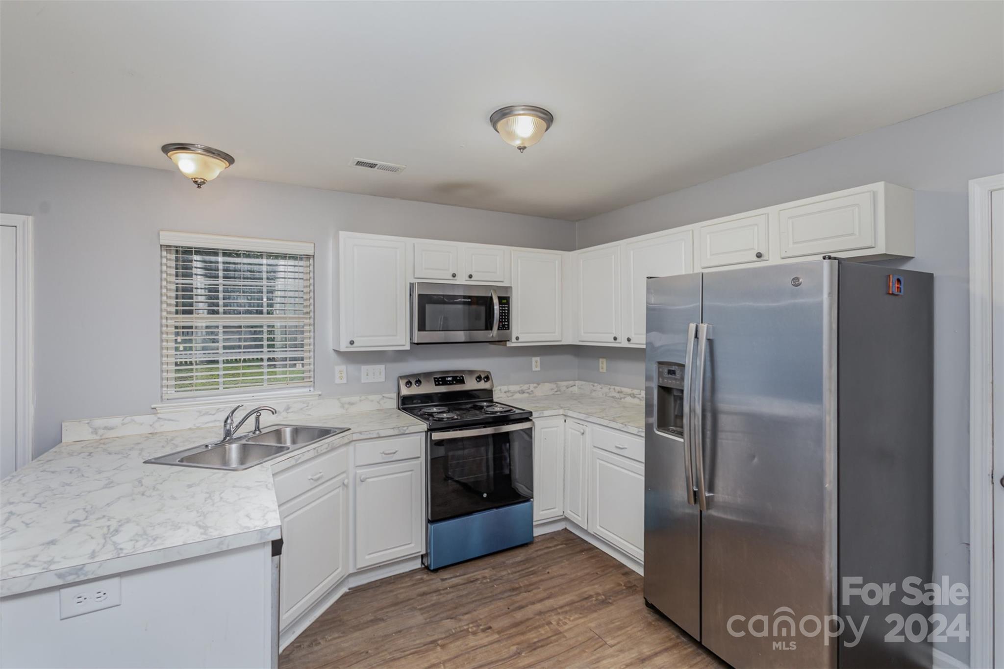 3917 Faith Church Road Indian Trail, NC 28079 - Photo 2 of 19 a kitchen with stainless steel appliances granite countertop a refrigerator stove and sink