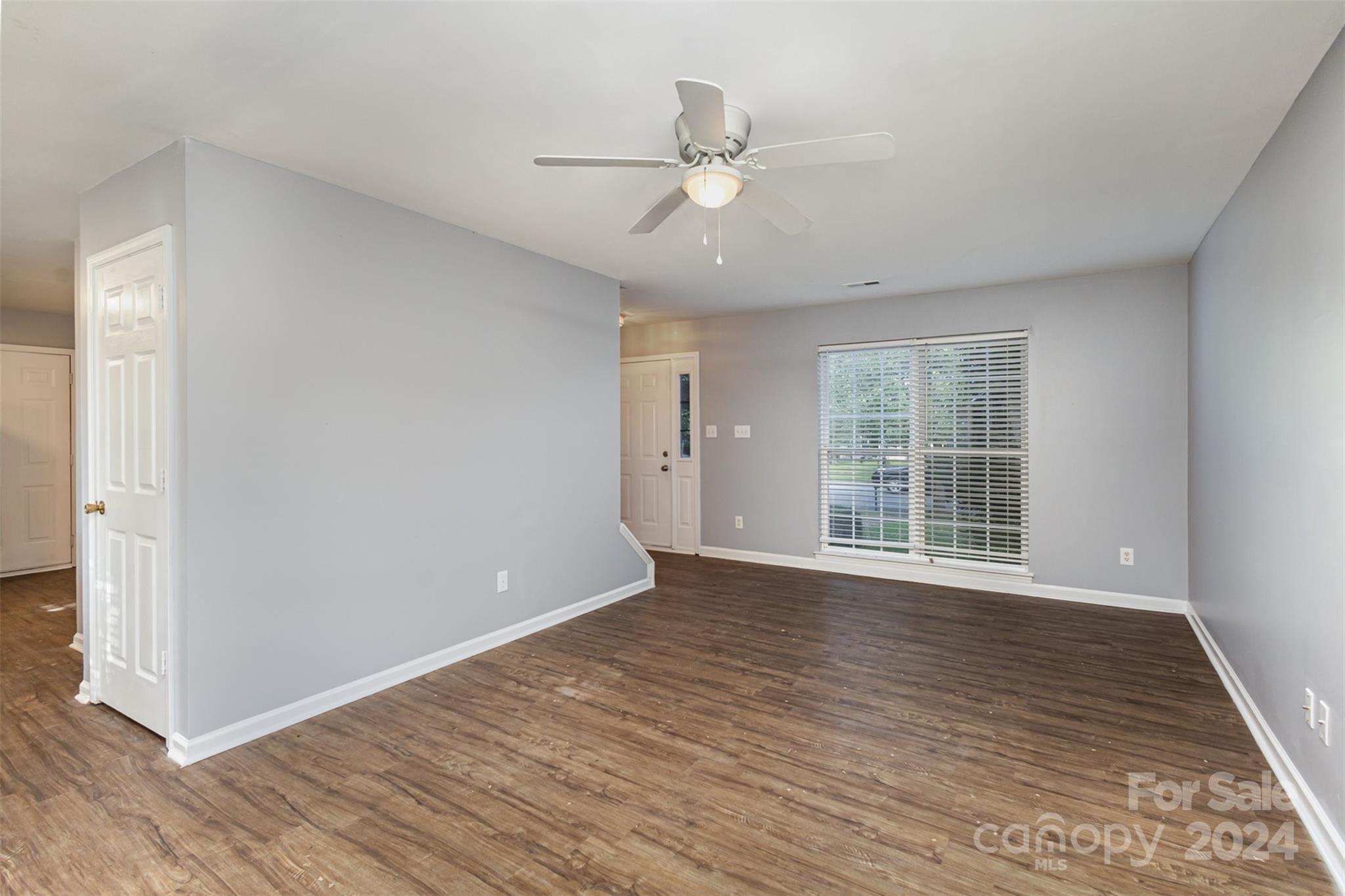 3917 Faith Church Road Indian Trail, NC 28079 - Photo 5 of 19 a view of an empty room with wooden floor and a window