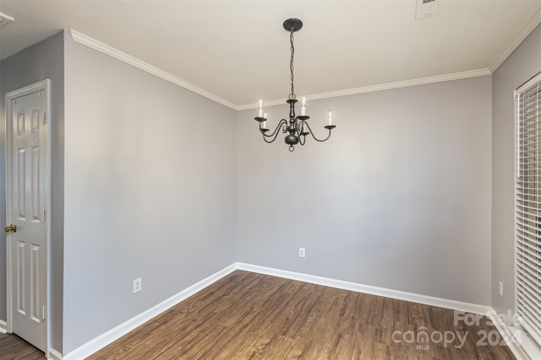 3917 Faith Church Road Indian Trail, NC 28079 - Photo 6 of 19 a view of a room with a chandelier fan and wooden floor