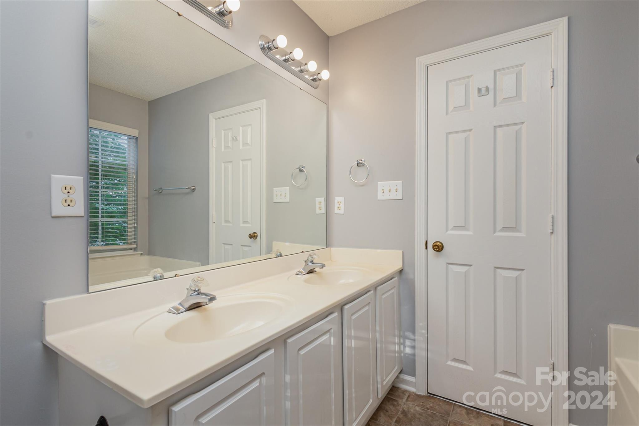 3917 Faith Church Road Indian Trail, NC 28079 - Photo 9 of 19 a bathroom with a sink double vanity and a mirror
