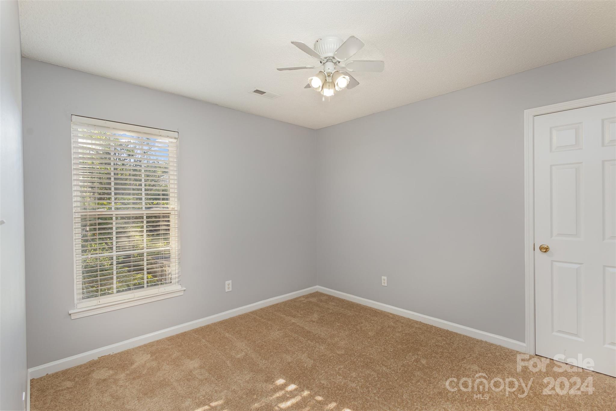 3917 Faith Church Road Indian Trail, NC 28079 - Photo 10 of 19 an empty room with windows and fan