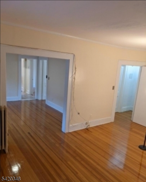 29 Warman Street Montclair, NJ 07042 - Photo 2 of 4 an empty room with wooden floor and windows