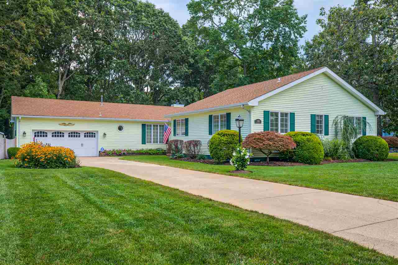 989 Tecumseh Road Erma, NJ 08204 - Photo 1 of 1 a front view of a house with a garden and porch