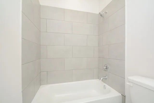 a bathroom with a sink a toilet and a window