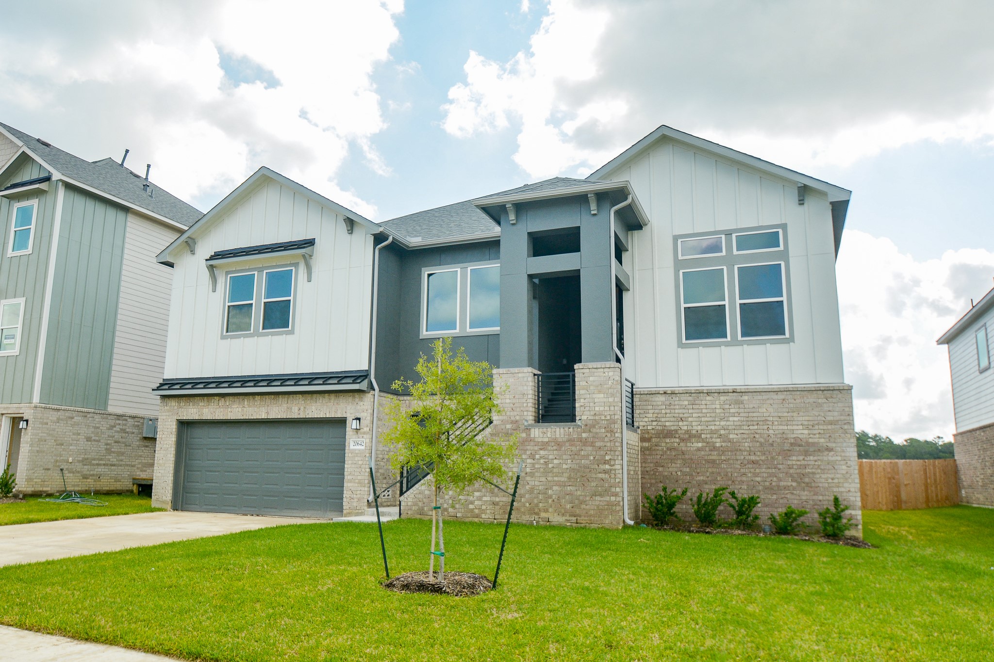 20642 Dynamic Court Humble, TX 77338 - Photo 3 of 32 a front view of a house with a garden and yard
