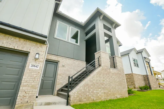 a view of a white house with many windows