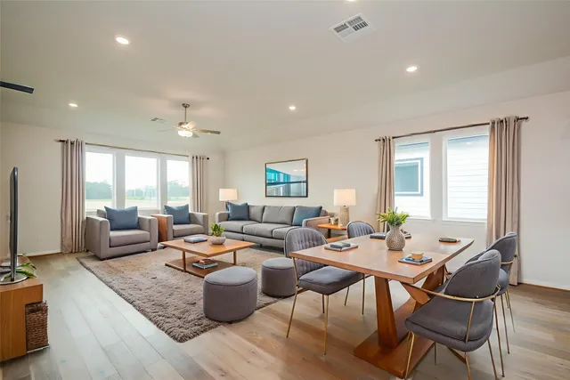 a living room with furniture wooden floor and a flat screen tv