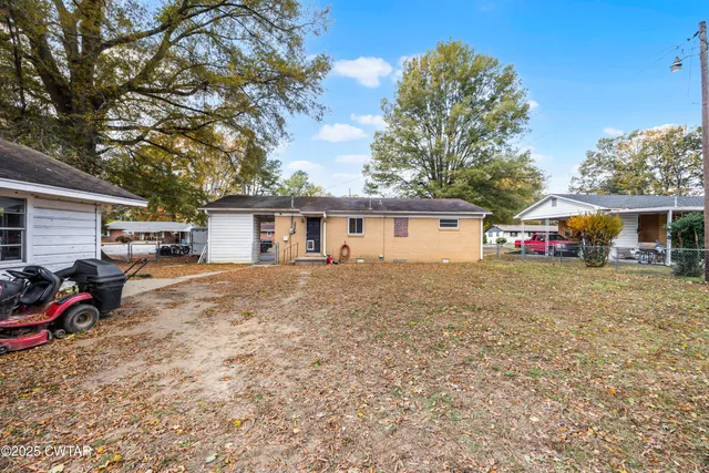 a front view of house with yard outdoor seating and barbeque oven